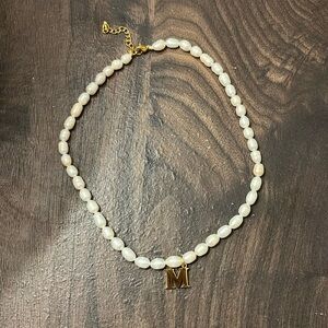 Fresh water pearl necklace with M initial.